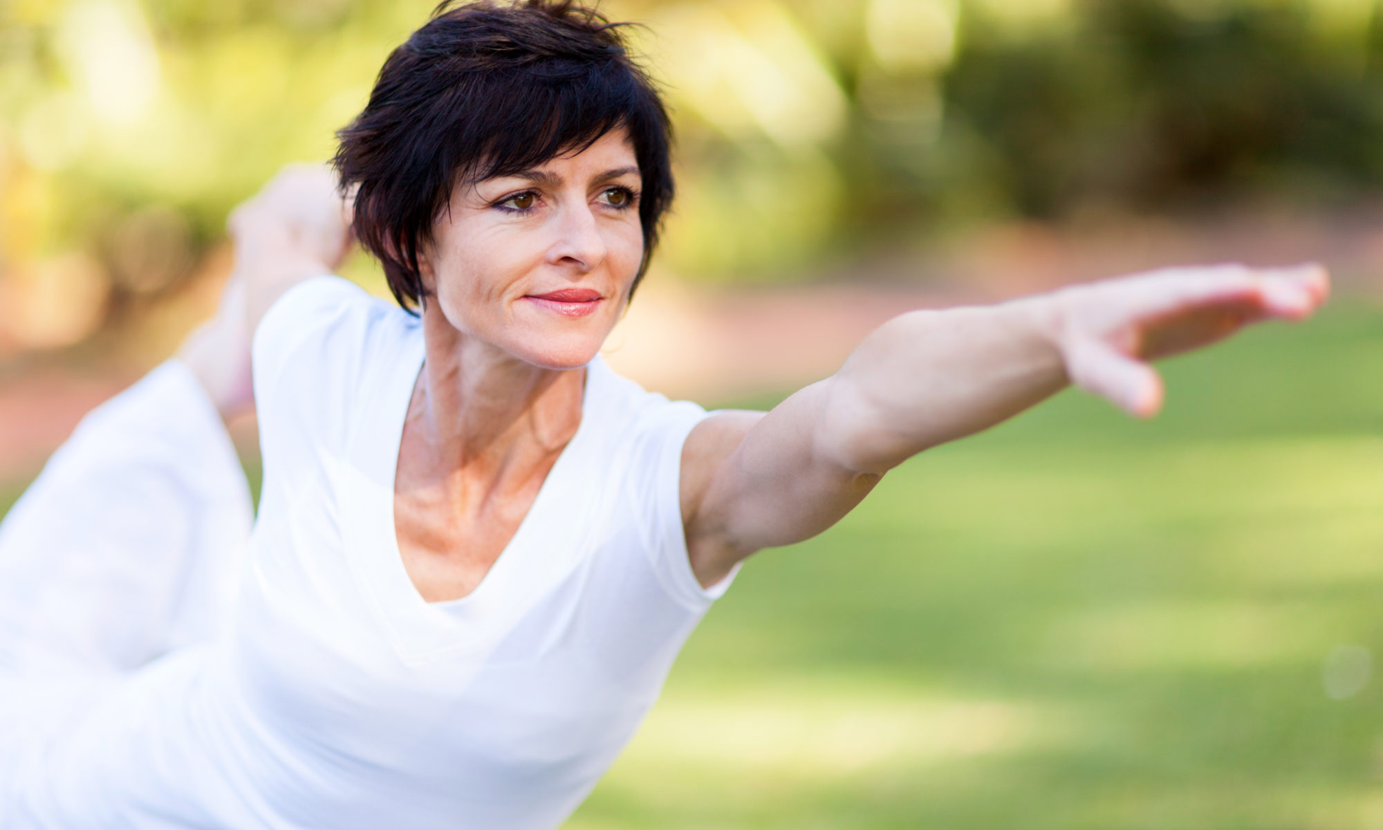 healthy middle aged woman stretching outdoors