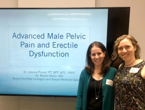 Drs. Jessica Probst and Rachel Rubin pose by "Advanced Male Pelvic Pain and Erective Dysfunction" sign