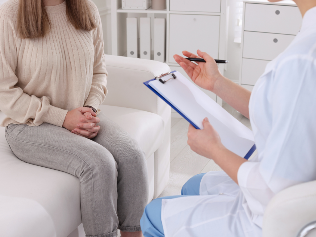 A woman discussing pain and dysfunction during sexual intercourse with her doctor